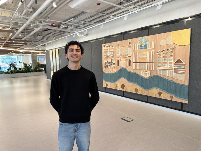 Kingston University fine art student Antonio Bourouphael with his artwork at Unilevers Kingston campus 2