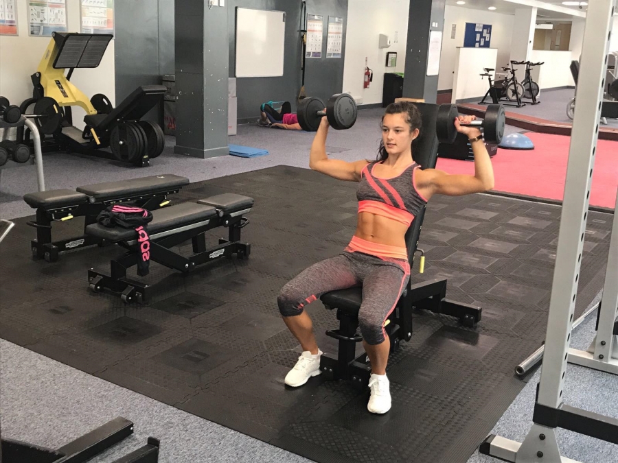 Lauren lifting weights in Arena Gym