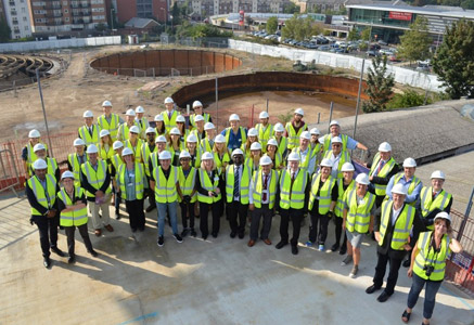 group photo of people all wearing high-vis jackets and hard hats