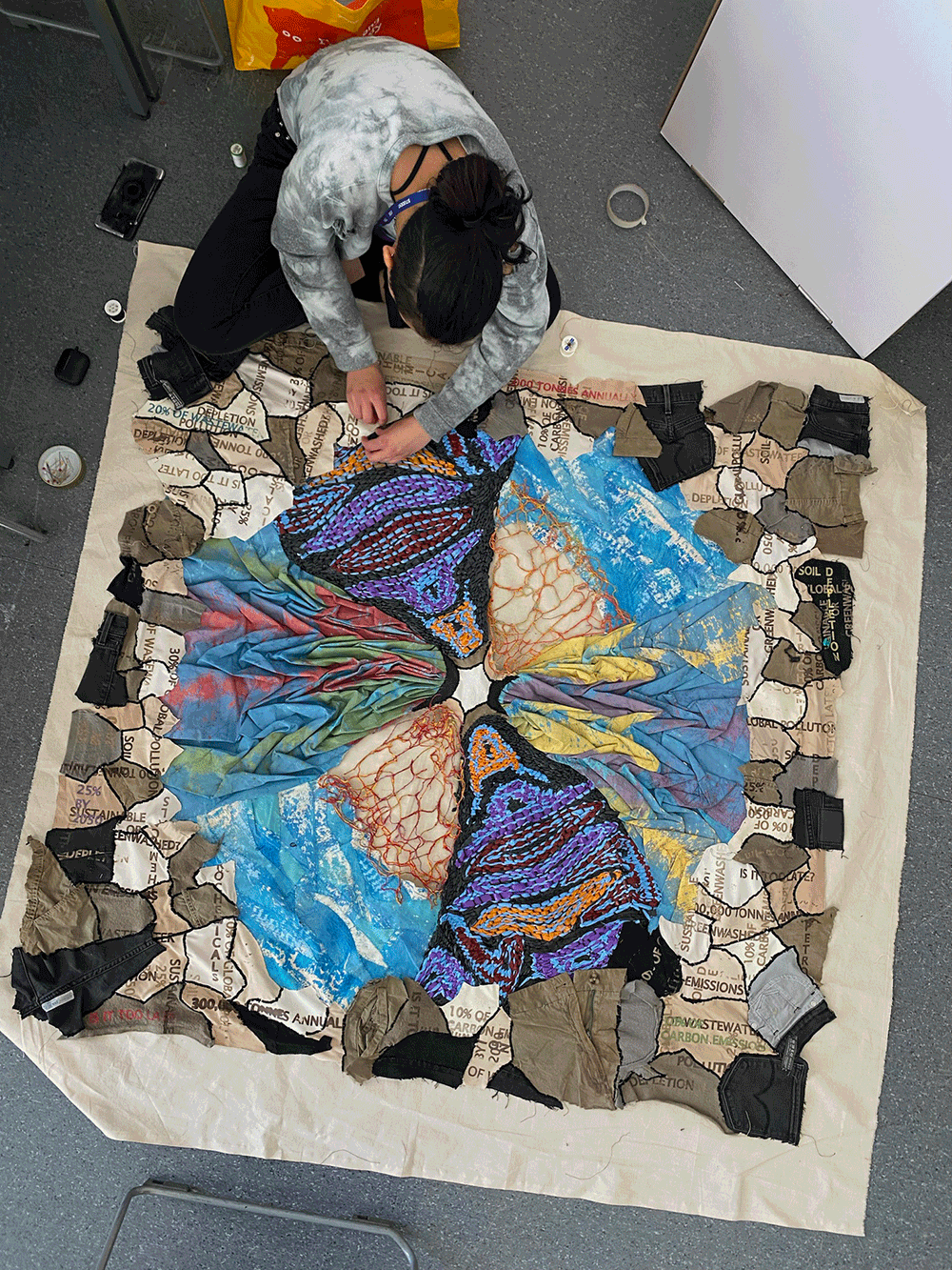 Overhead shot of student working on a piece of artwork