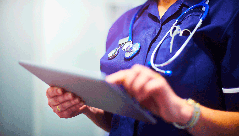 Close up of a nurse using a tablet